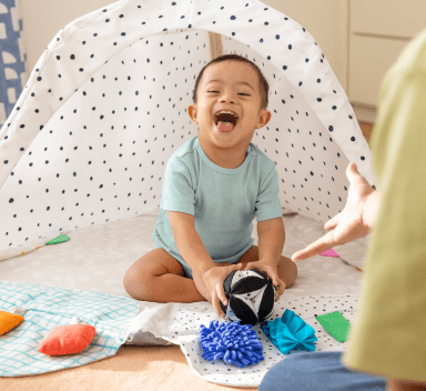 Baby sitting in The Play Gym by Lovevery