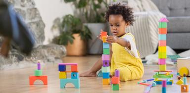 Child stacking blocks from The Block Set by Lovevery